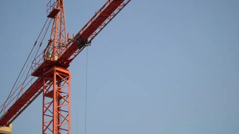 Close up of red construction crane pulley on blue sky Stock Footage 280270022