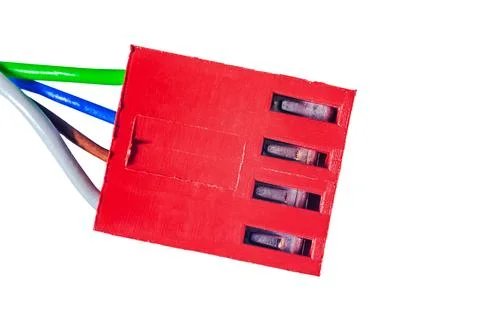 Close-up of a red electrical connector with multiple wires entering it on a.. Stock Photos