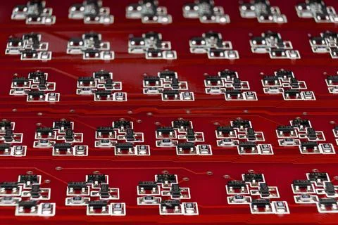 Close-up of a red electronic circuit board with many SMD components. Complex  Stock Photos