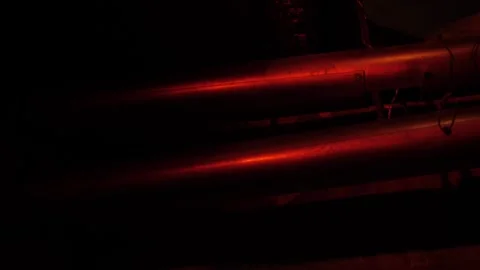 A close-up of the red emergency siren lamp flashing and reflecting off pipes. Stock Footage 312434305
