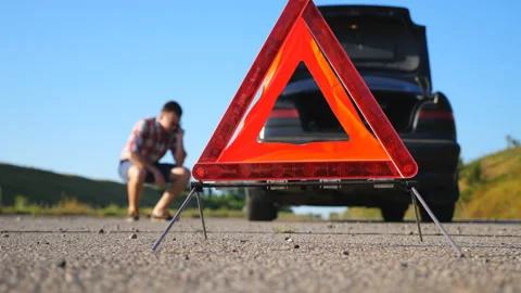 Close up of red emergency stop sign standing on road. Worried and angry driver Stock Footage 135404310