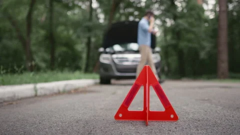 Close up of Red emergency stop triangle sign on road Stock Footage 233187040
