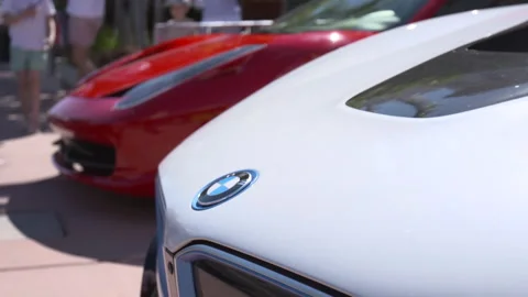 Close-up of Red Ferrari and White BMW Luxury Cars Stock-Footage 342563219