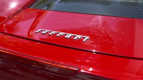 Close Up of Red Ferrari Rear Panel with Chrome Emblems 库存影片 342563139