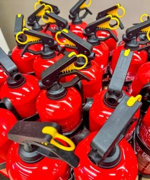 Close-Up of Red Fire Extinguishers in Hardware Store Display 스톡 사진