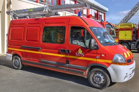 Close up of red fire trucks parked in a row at a French fire station service Stock Photos