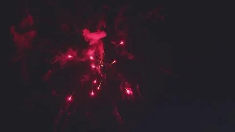 Close up red fireworks bursting and scattering bright sparks in night sky Video stock 340632709