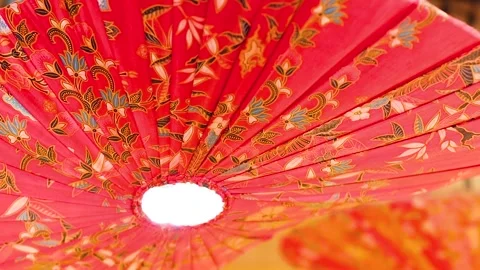 Close Up of Red Floral Patterned Parasol Lantern Under Warm Light Video stock 329204546