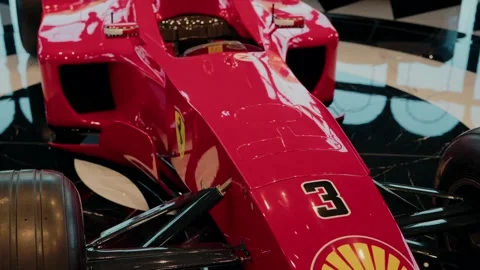 Close-up of a red Formula 1 race car, showcasing the sleek design, aerodynamic Stock Footage 294860305