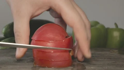 Close up of red fresh slices of tomato cut in pieces with knife Stock Footage 134069186