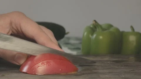 Close up of red fresh slices of tomato cut in pieces with knife Stock Footage 134069202
