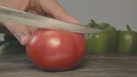 Close up of red fresh tomato cut in slices with knife Stock Footage 134068884