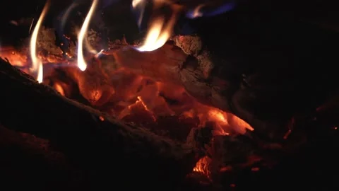 Close up of red glowing embers, flame in bonfire campfire, 4K Stock Footage 133912048