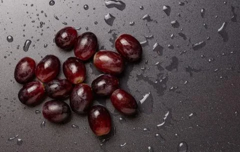 Close up of red grapes on black background with copy space. Stock Photos