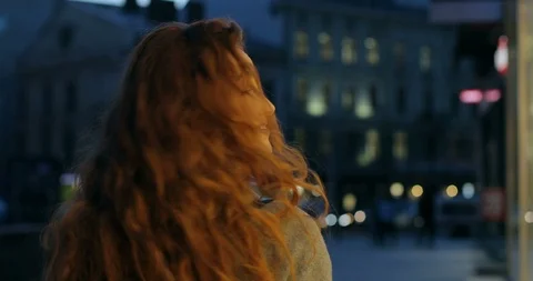 Close up of the red haired young cheerful Caucasian girl walking the street in Stock Footage 100979797