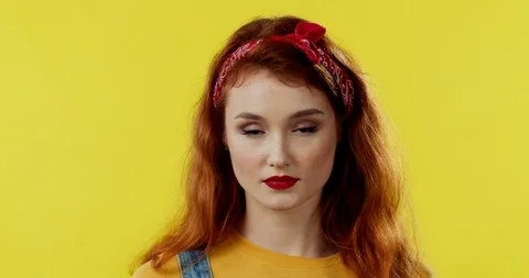 Close up of the red-haired young pretty girl rising her eyes to the camera and 스톡 동영상 105428736