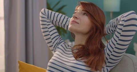 Close up of the red-haired young pretty woman resting wit eyes closed on the Stock Footage 122497818