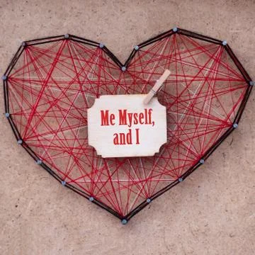 Close up of a red heart made of threads wound between nails. Me myself, and I Stock Photos