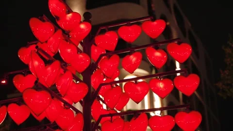 Close Up Red Heart Shaped LED Light Decorations on Tree city Installation at 스톡 동영상 338369409