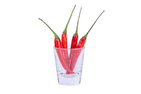 Close up red hot chilli pepper in a clear glass on isolated white background, Stock Photos