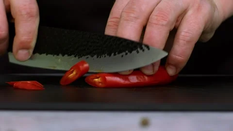 Close-up of red hot pepper. A chef expertly chops red peppers in slow-motion Видео 269121145