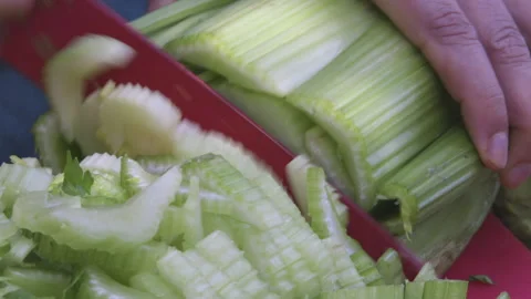 Close up of red knife cutting celery Stock-Footage 138125322
