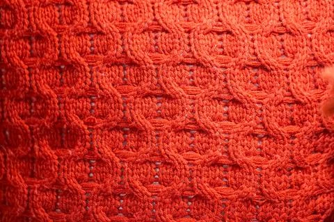 Close up of a red knit sweater with a pattern of circles Stock Photos