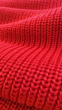 A close up of a red knit sweater. Stock Photos