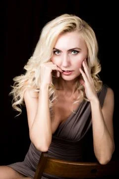 Close up of red lips of seductive blonde girl brought his hands to his face Stockfoto's