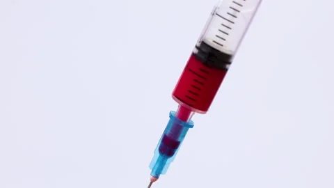Close up of red liquid injection in syringe on white background Stock Footage 307234991