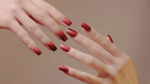 Close-up of red manicured hands, rubbing against each other and separating Stock Footage 319028152