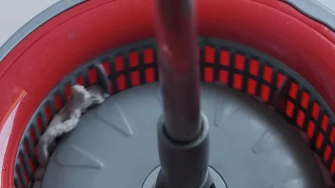 Close-up of a red mop being wrung out Stock Footage 248288247