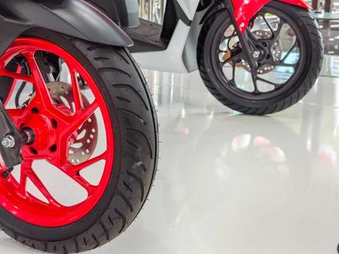 Close Up of Red Motorcycle Front Wheel and Rim in Showroom Stock Photos