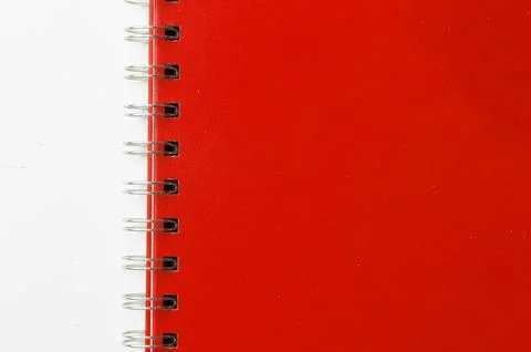 Close-up of a red notebook with checkered pages. Spiral notebook isolated Stock Photos