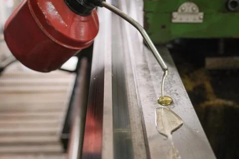 Close-up of a Red Oiler Can Lubricating the Ways of an Industrial Lathe Stock Photos