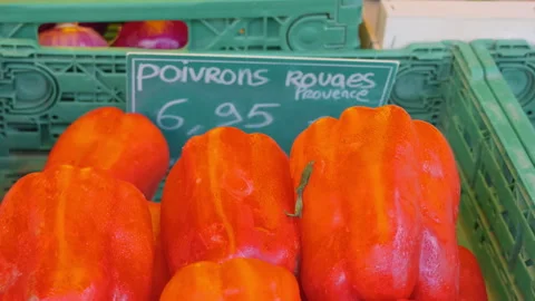 Close-up of red onions and red bell peppers in crates at a market, Cote d'Azur, Stock Footage 344799668