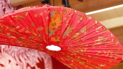 Close Up of a Red Patterned Asian Parasol Lantern Hanging Indoors Video stock 327426025