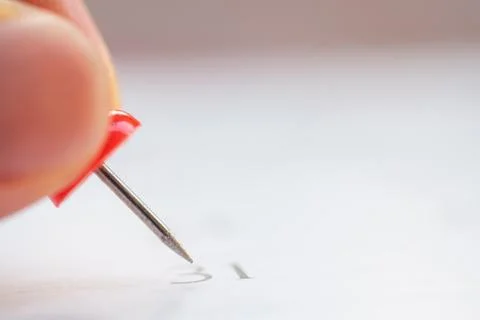Close up red pin on calendar. Stock Photos