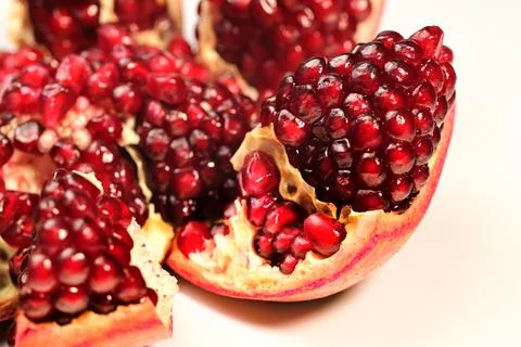 A close up of a red pomegranate fruit with a bite taken out of it Stock Photos