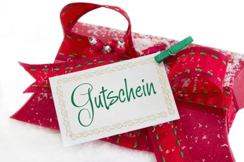 Close up of red present box and coupon with german text for christmas Stock Photos