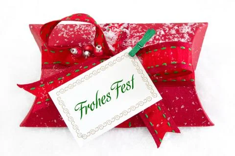 Close up of red present box with german text for christmas on white backgroun Stock Photos
