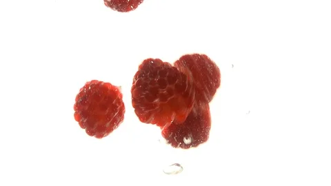 Close up red raspberries thrown floating in water 動画素材 94075805