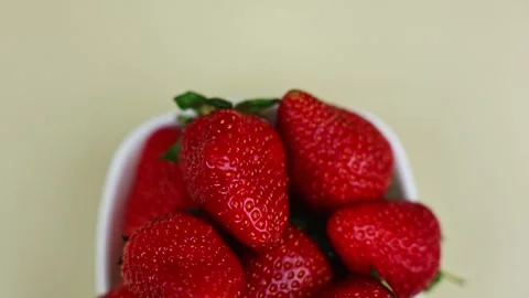 Close-up of red ripe strawberries lying in a white bowl, the camera smoothly Stock Footage 317141822