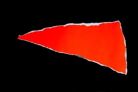 Close up of a red ripped or torn piece of paper with copy space, isolated b.. Stock Photos