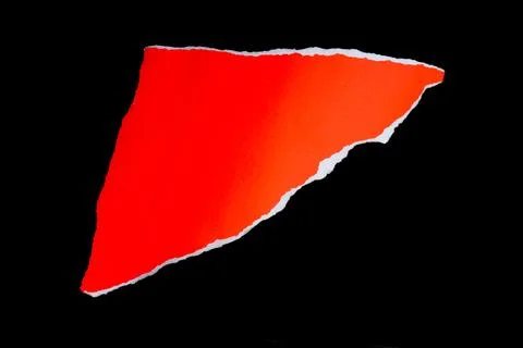 Close up of a red ripped or torn piece of paper with copy space, isolated b.. Stock Photos
