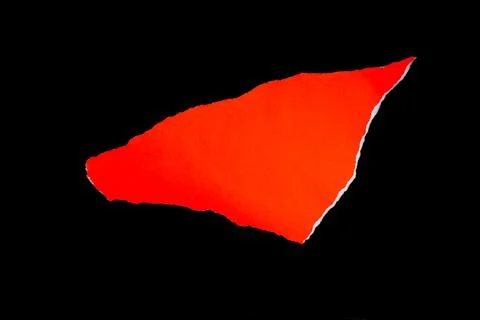 Close up of a red ripped or torn piece of paper with copy space, isolated b.. Stock Photos