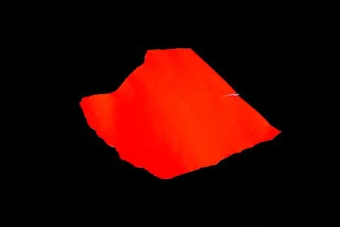 Close up of a red ripped or torn piece of paper with copy space, isolated b.. Stock Photos