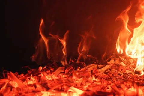 Close-up of red roaring flames burning in fireplace. Romantic and mesmerizing Stock Photos