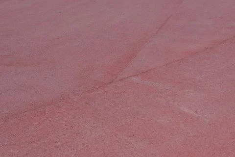 Close up of red rubber pavement with overlapping seams, abstract background Stock Photos