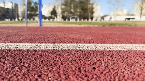 Close-up of red running track with white markings, outdoor sports stadium Vídeo Stock 333147321
